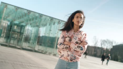 Portrait-of-young-African-American-woman-posing-to-a-camera,-outdoors.