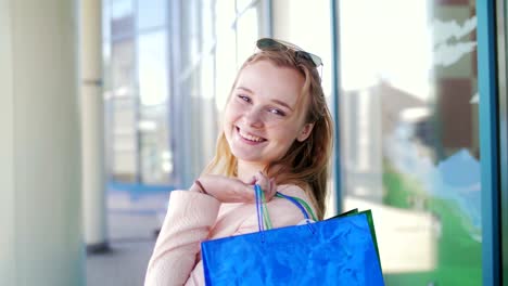 Portrait-of-a-beautiful-girl-who-left-the-store-with-shopping.