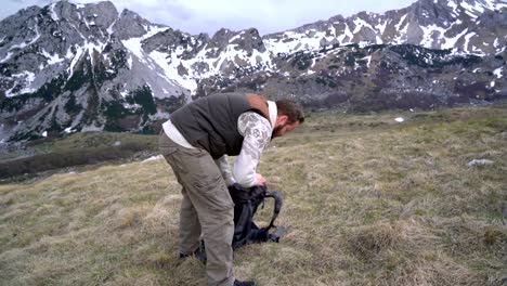 Hiker-going-along-grassy-slope