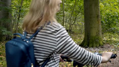 Pretty-woman-on-a-bike-ride-in-the-forest