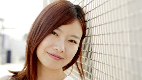 Attractive-Chinese-Woman-in-Urban-Environment.-Looking-at-the-Camera-with-Dark-Eyes-and-Dyed-Hair.