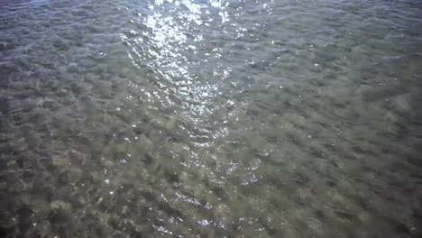 Ocean-with-waves-and-sand-in-sunny-day.-Natural-texture