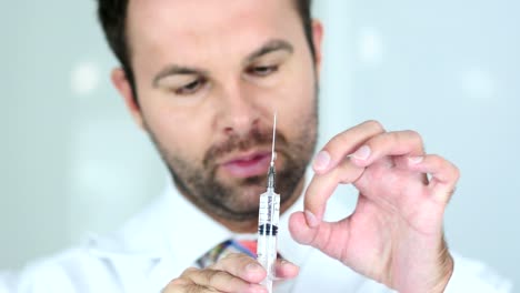 Holding-Injection,-Close-Up-of-Doctor-in-Mask-Ready-to-inject