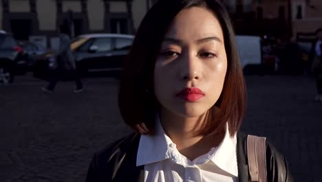 Portrait-of-sad-thoughtful-young-asian-woman-in-the-city---steady-cam