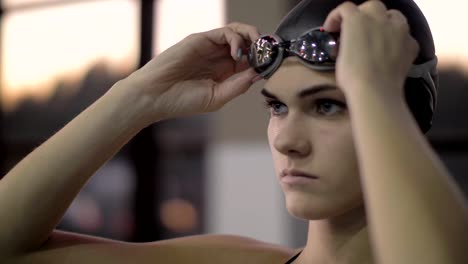 Portrait-woman-swimmer-putting-goggles-on-face-for-underwater-floating-in-pool