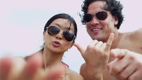 Portrait-young-Asian-Chinese-couple-filming-beach-selfie