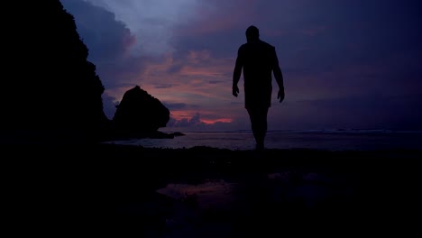 Man-rising-hands-up-and-enjoying-the-moment-at-sunrise