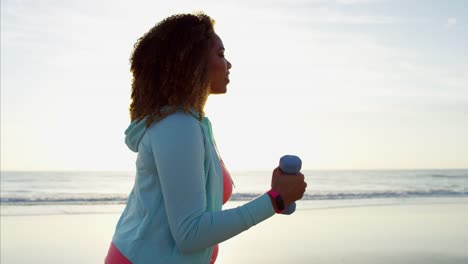 Portrait-of-Ethnic-female-in-sportswear-with-dumbbells