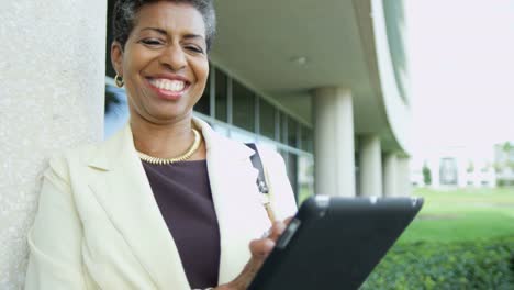 Portrait-of-African-American-female-lecturer-holding-touchscreen