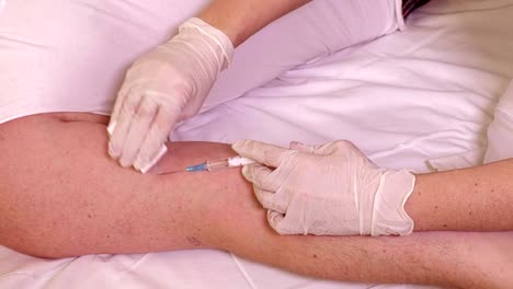 Female-doctor-with-syringe-near-patient