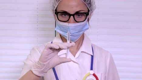 Nurse-checking-syringe-before-injection