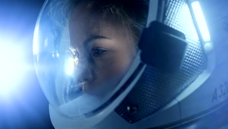 Portrait-of-the-Beautiful-Female-Astronaut-Space-Walking,-Looking-around-in-Wonder,-Space-Station-Illuminates-Her-Face.-Space-Travel,-Exploration-and-Solar-System-Colonization-Concept.