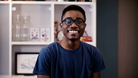 Young-African-American-man-shows-different-emotion.-Handsome-black-guy-in-glasses-laughs,-then-serious-and-again.-4K