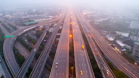 Aerial-view-traffic-on-highway-with-mist-in-morning.