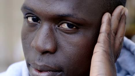 Thoughtful-handsome-young-black-man-staring-at-camera