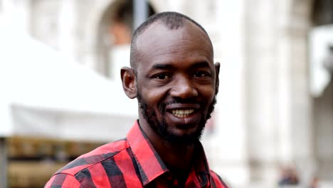 handsome-black-man-in-the-street-looks-at-the-camera,close-up