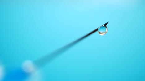 Syringe-needle-medicine-with-liquid-medicine-drop-on-a-green-background