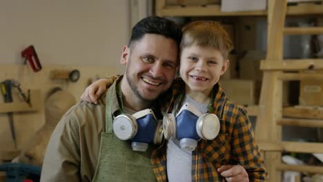 Happy-Father-and-Son-Posing-in-Workshop