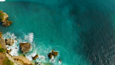 Aerial-view-of-turquoise-tropical-ocean-and-rocks-in-Bali.