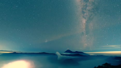 Milkyway-galaxy-moving-from-left-to-right-over-misty-Bromo-Tengger-Semeru-National-Park-a-time-lapse-video-clip