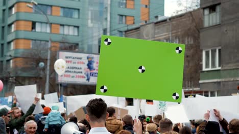 European-people-at-demonstration.-Man-with-a-banner-screaming-into-a-mouthpiece.