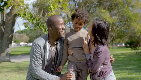 Cute-Mixed-race-son-hugging-and-kissing-happy-parents