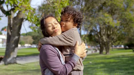 Curly-African-American-son-hugging-and-kissing-mother