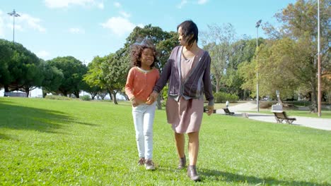 African-American-daughter-holding-hands-with-Asian-mother