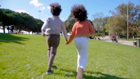 African-American-children-running-to-parents-on-green-lawn