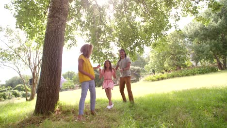 Atractiva-madre-y-Padre-e-hija-en-el-parque-lleva-a-oscilación.