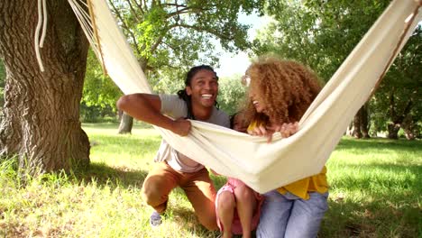 Photogenic-Multi-ethnic-family-relaxing-together-on-a-hammock