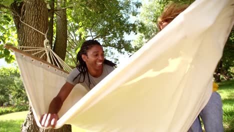 Photogenic-Multi-ethnic-family-relaxing-together-on-a-hammock