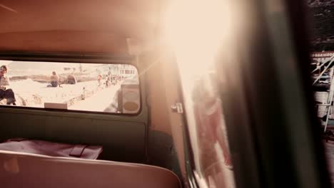 Young-couple-taking-a-suitcase-in-their-vintage-van