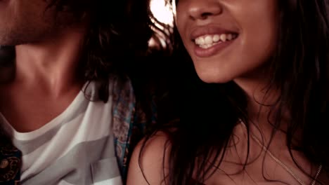 Happy-young-couple-enjoying-a-road-trip-with-friends