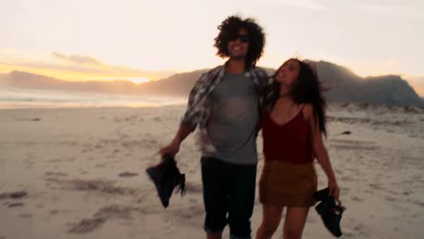 Hipster-young-couple-have-a-romantic-walk-on-the-beach