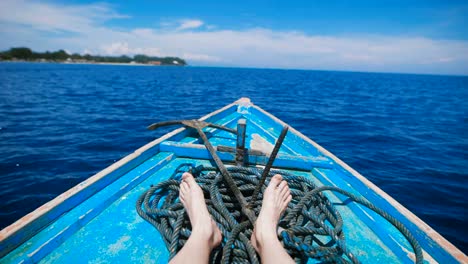 Ocean-island-of-Bali.-Boat-tour.-Young-man-in-a-boat-on-the-ocean-excursions.-Stunningly-clear-ocean,-year-round-sunshine,-paradise-island---idyllic-picture