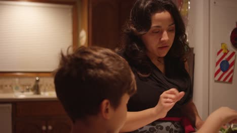 A-little-boy-helping-his-mom-prepare-food-in-the-kitchen