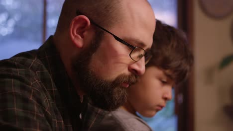 Close-up-of-a-father-and-son-playing-a-board-game-at-home