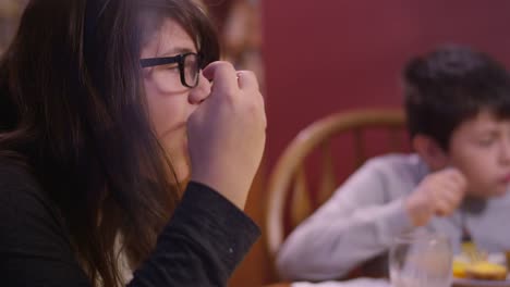 Siblings-eating-dinner-at-the-kitchen-table