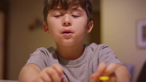 A-little-boy-using-cookie-cutters-in-the-kitchen-at-home