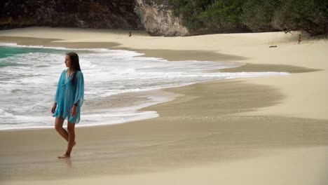 Girl-walking-on-the-beach.-Bali,-Indonesia