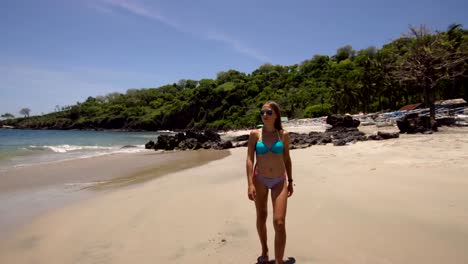 Girl-walking-on-the-beach.-Bali,-Indonesia