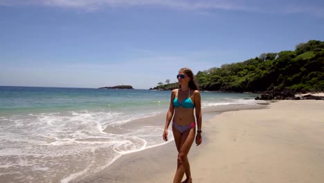 Girl-walking-on-the-beach.-Bali,-Indonesia