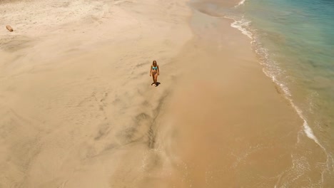 Girl-walking-on-the-beach.-Bali,-Indonesia