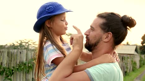 Father-having-fun-holding-his-little-daughter-in-arms