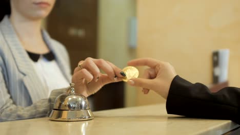 Woman-gives-a-tips-of-bitcoin-to-the-manager-in-hotel