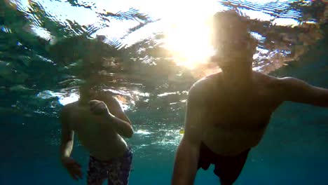 young-boy-snorkeling-with-father-on-Bali,-Indonesia