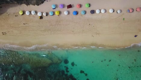 Beach-umbrellas-and-blue-ocean.-Beach-scene-from-above