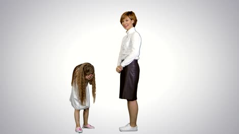 Beautiful-mother-and-daughter-giving-high-five-and-smiling-each-other-on-white-background