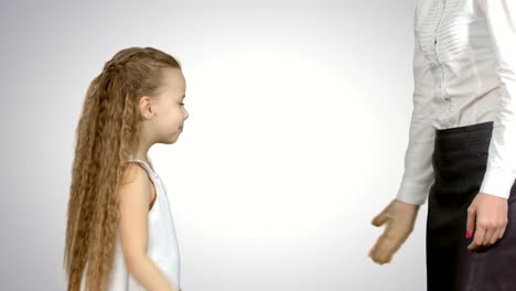 Happy-mother-giving-high-five-to-her-little-daughter-on-white-background